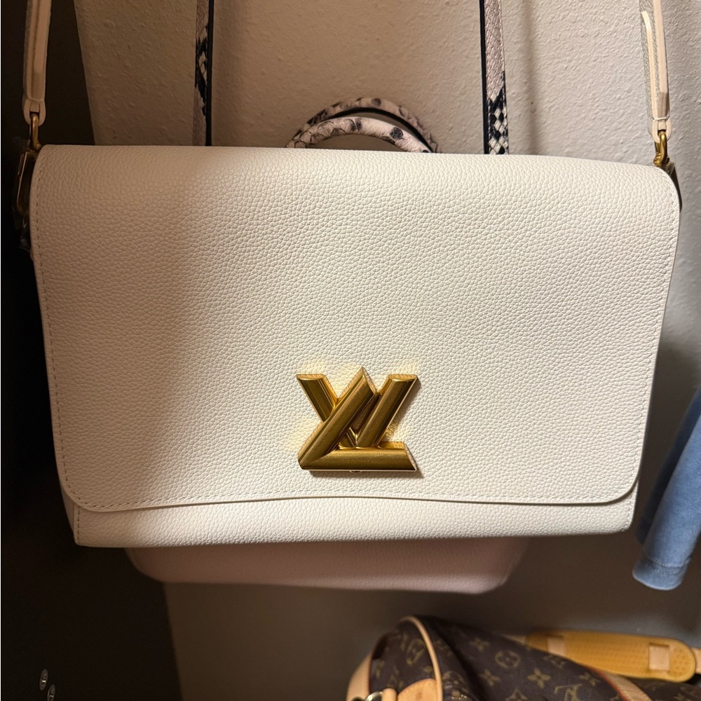 Louis Vuitton Cream Go-14 never used. Mint condition this is not a twist.